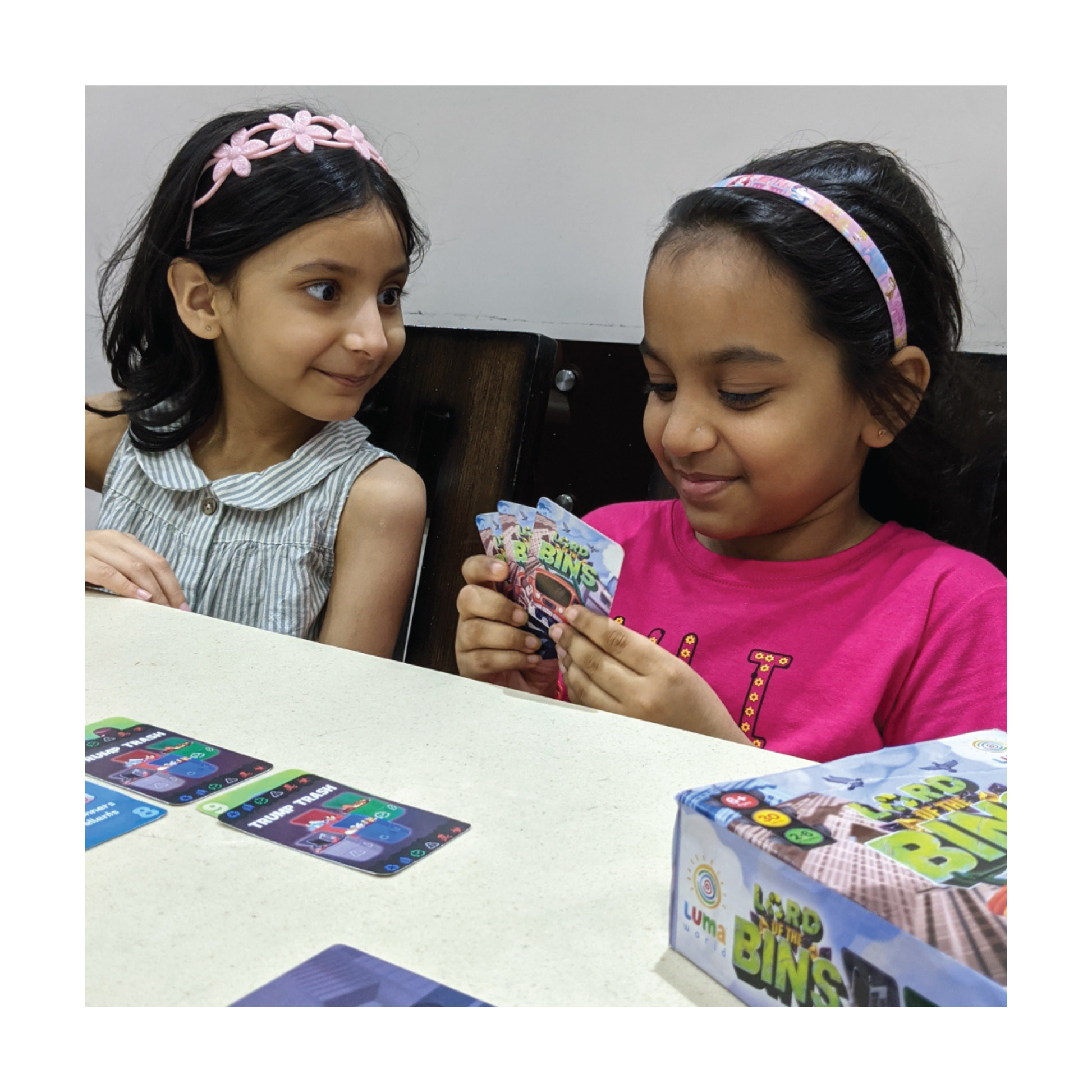 Children playing Lord of the Bins, engaged in sorting trash cards.